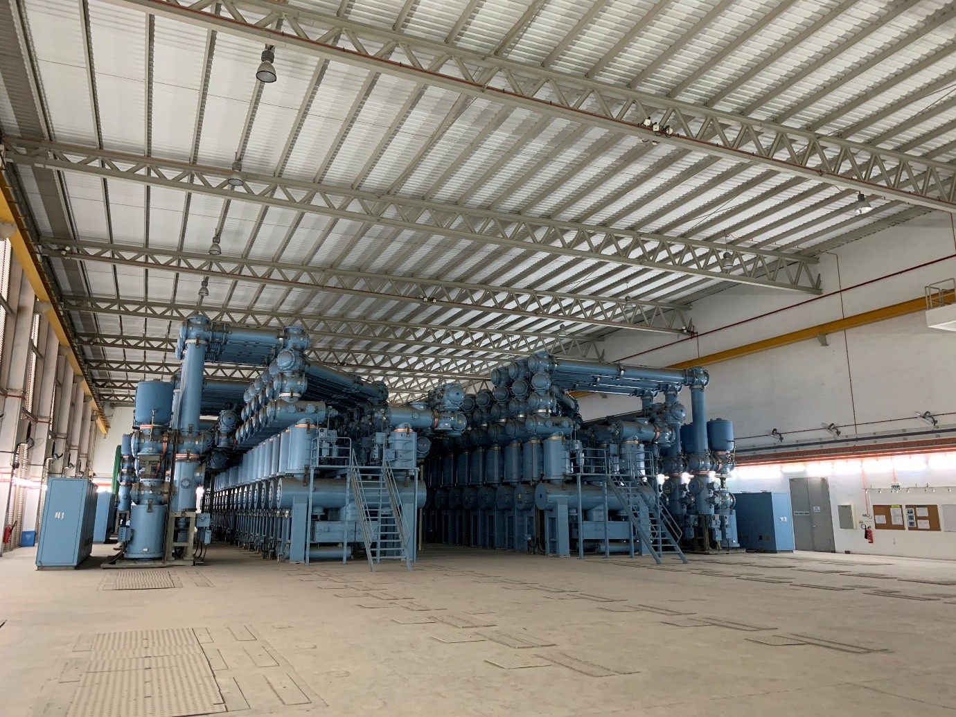 Large indoor 400kV Gas Insulated Switchgear installation with blue metal components.
